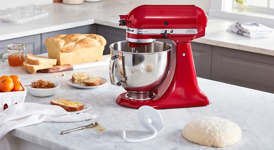 Red KitchenAid® stand mixer on countertop with loaf of bread, dough hook attachment and fresh ball of dough Red KitchenAid® stand mixer on countertop with loaf of bread, dough hook attachment and fresh ball of dough